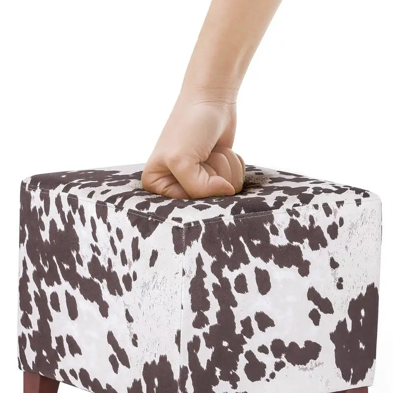 Puf cúbico con estampado de vaca, negro y marrón, reposapiés individual
