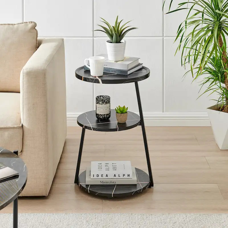 Mesa auxiliar redonda de tres niveles en blanco y negro con patas metálicas asimétricas